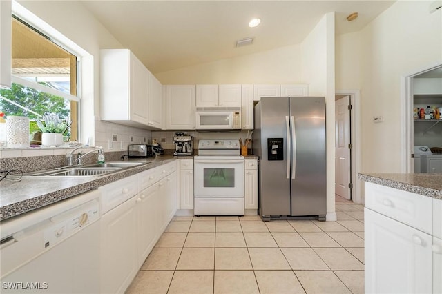 kitchen with white appliances, light tile patterned floors, sink, and white cabinets