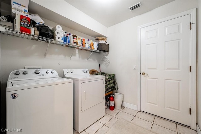 washroom with light tile patterned flooring and independent washer and dryer