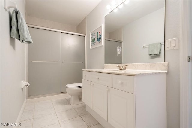 bathroom featuring walk in shower, vanity, toilet, and tile patterned flooring