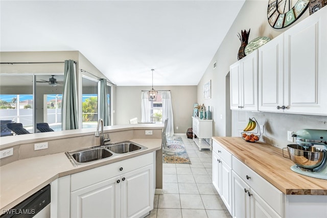 kitchen featuring butcher block countertops, white cabinets, and sink