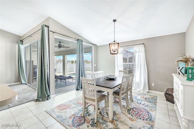 tiled dining room with lofted ceiling and ceiling fan