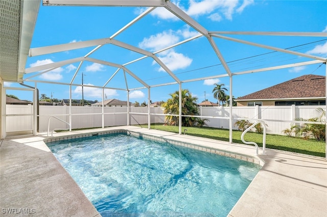 view of pool featuring glass enclosure and a patio