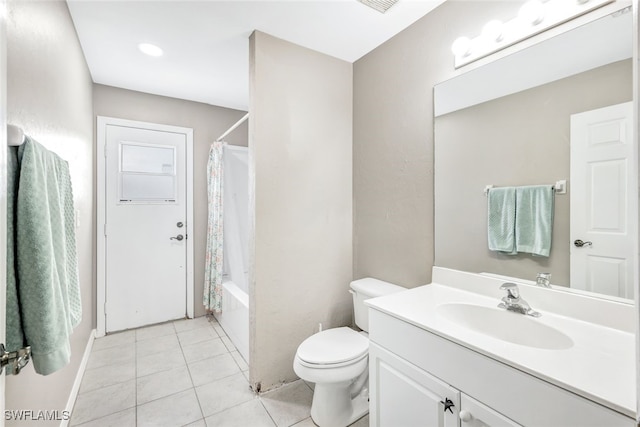 full bathroom with shower / bath combo with shower curtain, tile patterned flooring, vanity, and toilet