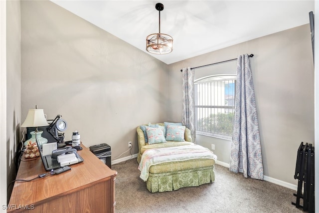 carpeted home office with a chandelier