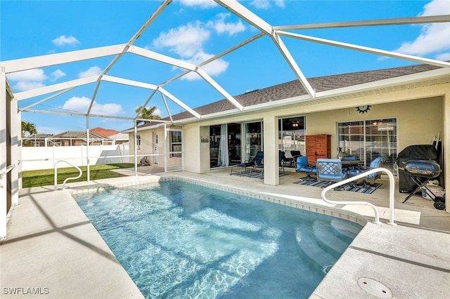 view of swimming pool with a patio and glass enclosure