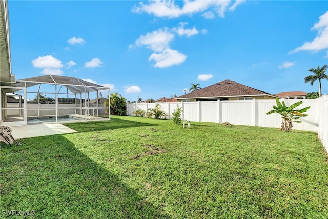 view of yard featuring a pool, glass enclosure, and a patio area