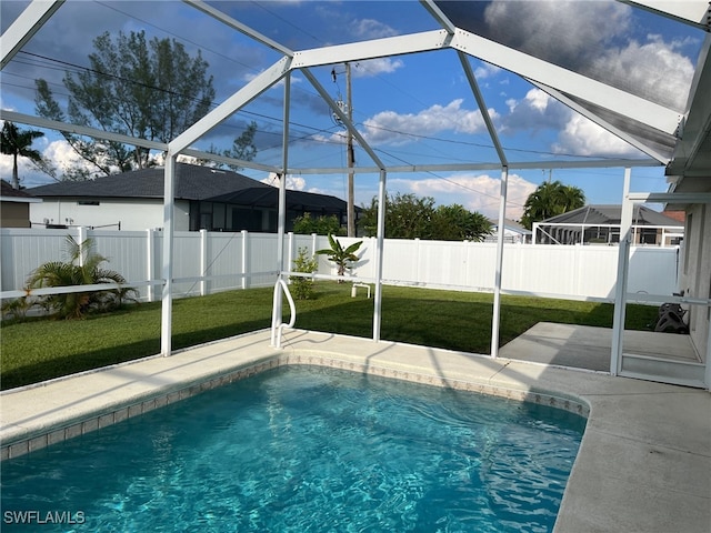 view of swimming pool with a lawn, a patio, and glass enclosure