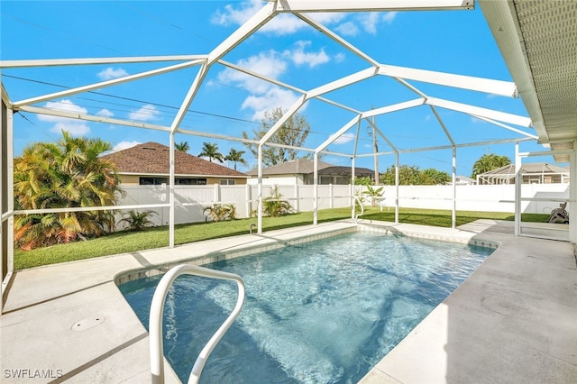 view of swimming pool featuring glass enclosure, a patio, and a lawn