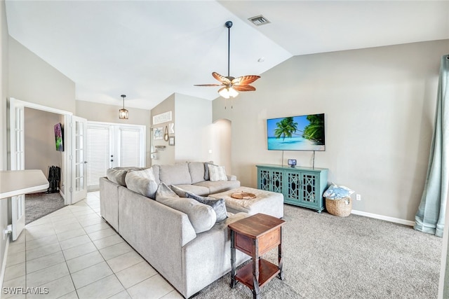 tiled living room with ceiling fan and vaulted ceiling