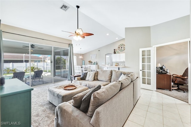 tiled living room with high vaulted ceiling and ceiling fan