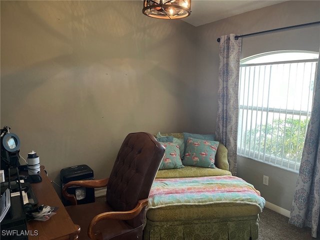 bedroom with carpet floors, a notable chandelier, and multiple windows