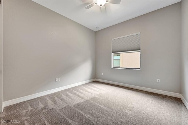 spare room featuring ceiling fan and carpet