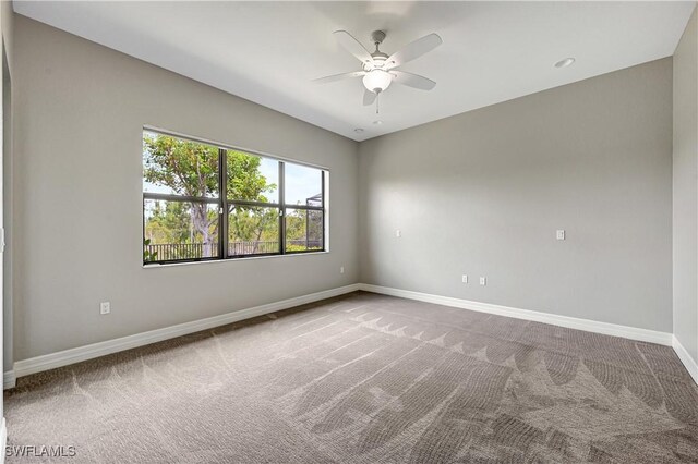 unfurnished room featuring ceiling fan and carpet