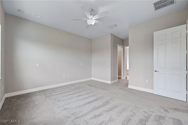 empty room featuring light carpet and ceiling fan