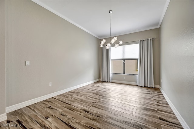 spare room with light hardwood / wood-style floors, crown molding, and an inviting chandelier