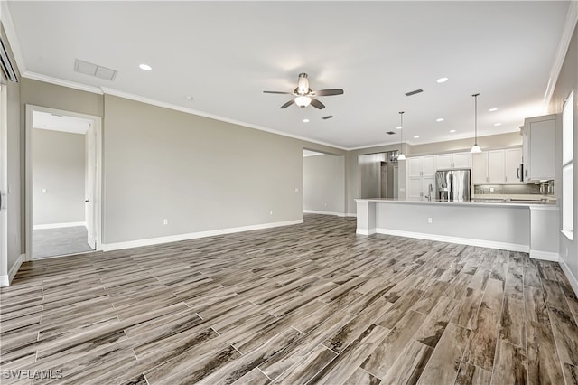 unfurnished living room with ceiling fan, ornamental molding, and light hardwood / wood-style flooring