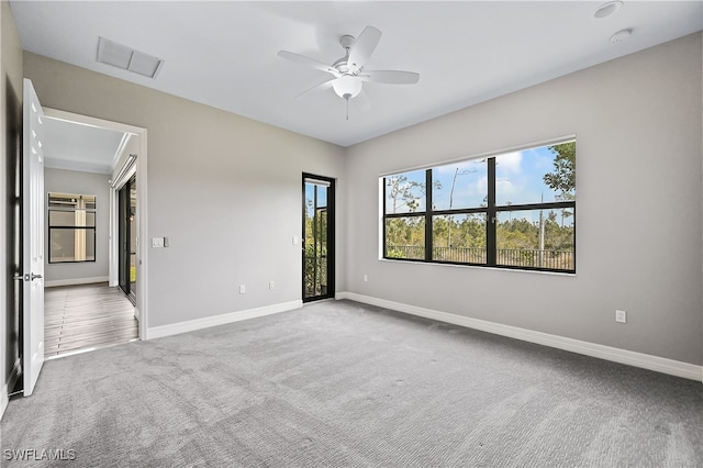 spare room featuring carpet floors and ceiling fan