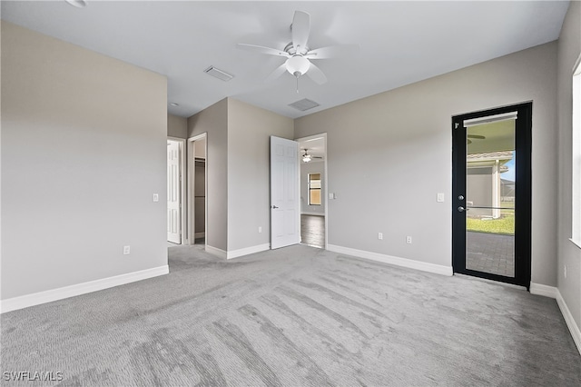 interior space featuring light carpet, a closet, a spacious closet, and ceiling fan