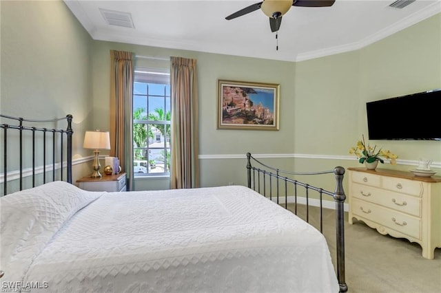 bedroom with ceiling fan, carpet flooring, visible vents, baseboards, and ornamental molding