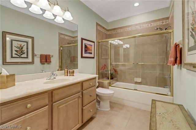 bathroom featuring toilet, tile patterned flooring, enclosed tub / shower combo, and vanity