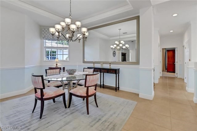 dining area featuring ornamental molding, a tray ceiling, a notable chandelier, and light tile patterned floors