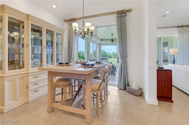 dining area with light tile patterned floors, recessed lighting, and an inviting chandelier