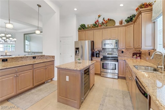 kitchen with light stone countertops, tasteful backsplash, appliances with stainless steel finishes, and a sink