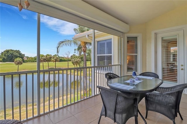 sunroom / solarium featuring a water view