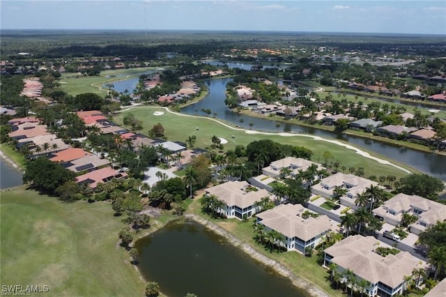 drone / aerial view with golf course view, a water view, and a residential view