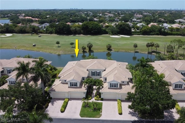 drone / aerial view featuring view of golf course and a water view