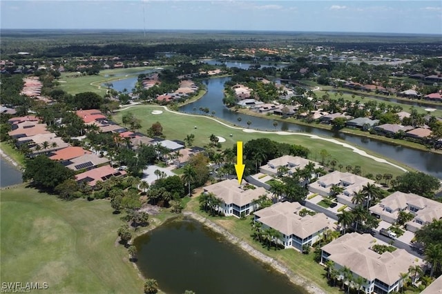 drone / aerial view with a residential view, a water view, and golf course view