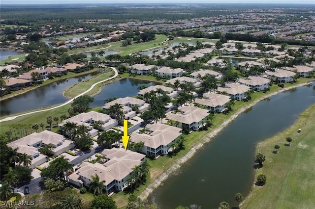 drone / aerial view with a water view and a residential view