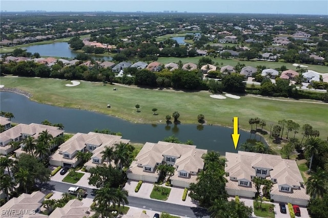 drone / aerial view with a residential view, a water view, and golf course view