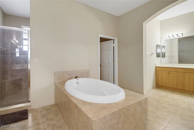 bathroom featuring vanity, plus walk in shower, and tile patterned flooring