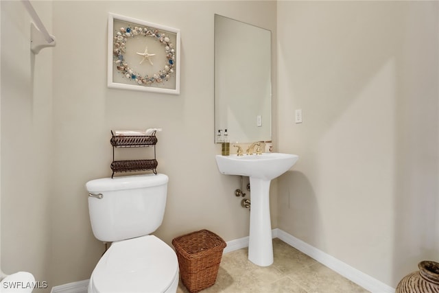 bathroom with toilet and tile patterned flooring