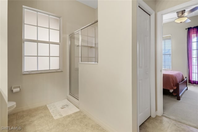 bathroom with ceiling fan, toilet, tile patterned floors, and walk in shower