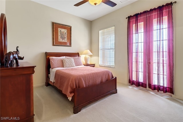 bedroom with multiple windows, carpet flooring, and ceiling fan