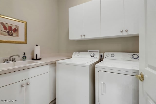 washroom featuring separate washer and dryer, cabinets, and sink