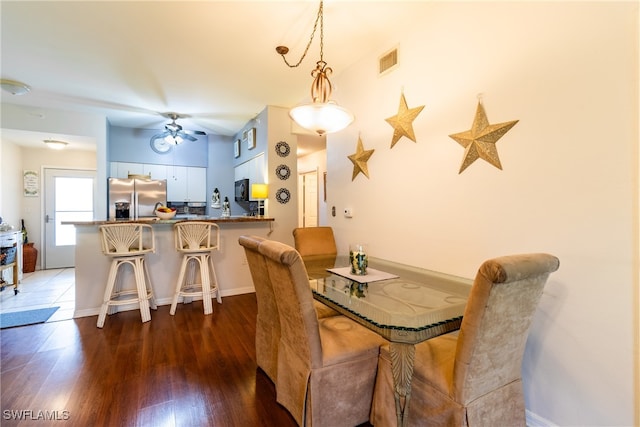 dining space featuring dark wood-type flooring and ceiling fan