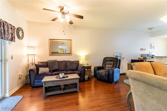 living room with dark wood-type flooring and ceiling fan