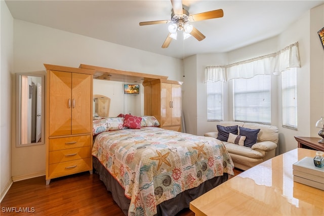 bedroom with dark hardwood / wood-style floors and ceiling fan