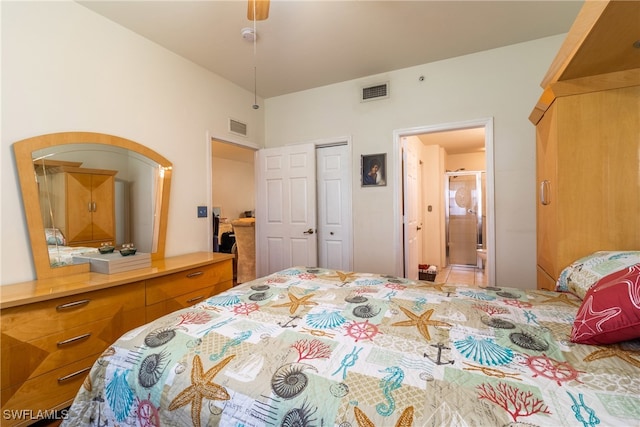 bedroom with a closet, ensuite bathroom, and ceiling fan