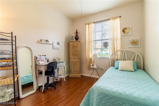 bedroom with dark hardwood / wood-style floors