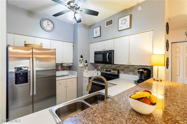 kitchen featuring decorative backsplash, white cabinets, stainless steel appliances, and sink