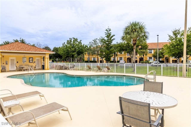 view of swimming pool with a patio