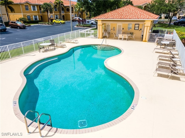 view of swimming pool with a patio