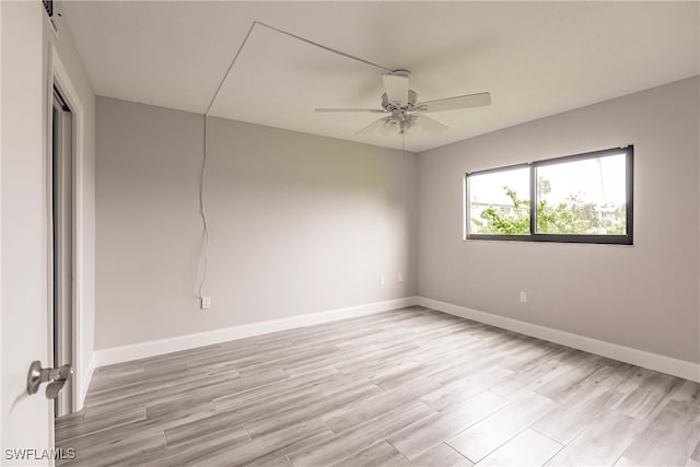 spare room with light hardwood / wood-style flooring and ceiling fan