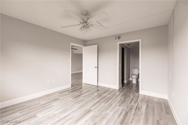 unfurnished bedroom with ceiling fan, connected bathroom, and light hardwood / wood-style flooring