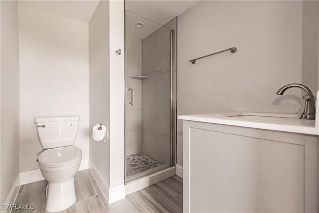 bathroom with tile patterned flooring, vanity, toilet, and an enclosed shower