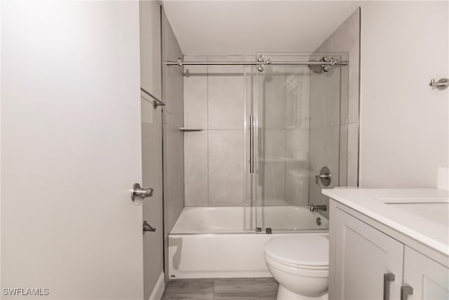 full bathroom featuring vanity, toilet, and bath / shower combo with glass door